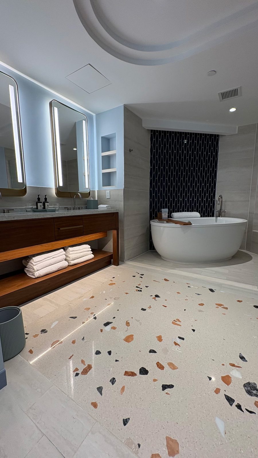 A suite bathroom with a freestanding tub and terrazzo floor